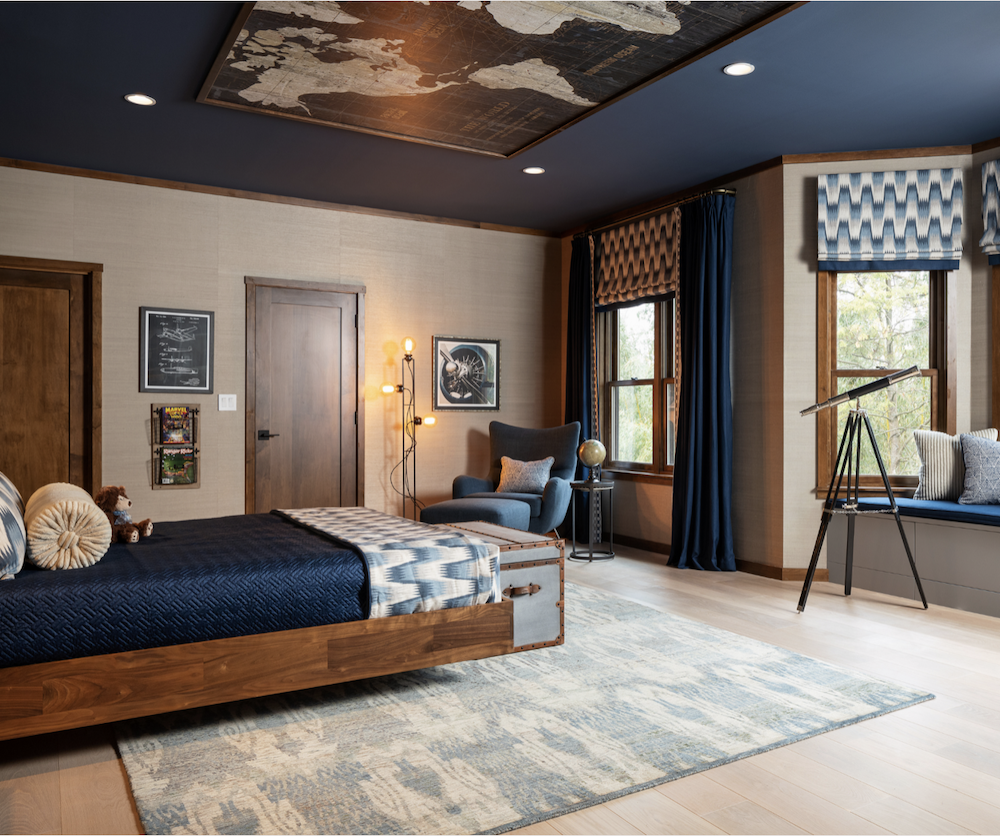 custom ceiling in this guest bedroom with wood bed frame and large area rug