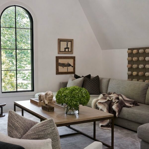 intimate living room area with grey couch and comfy seating.