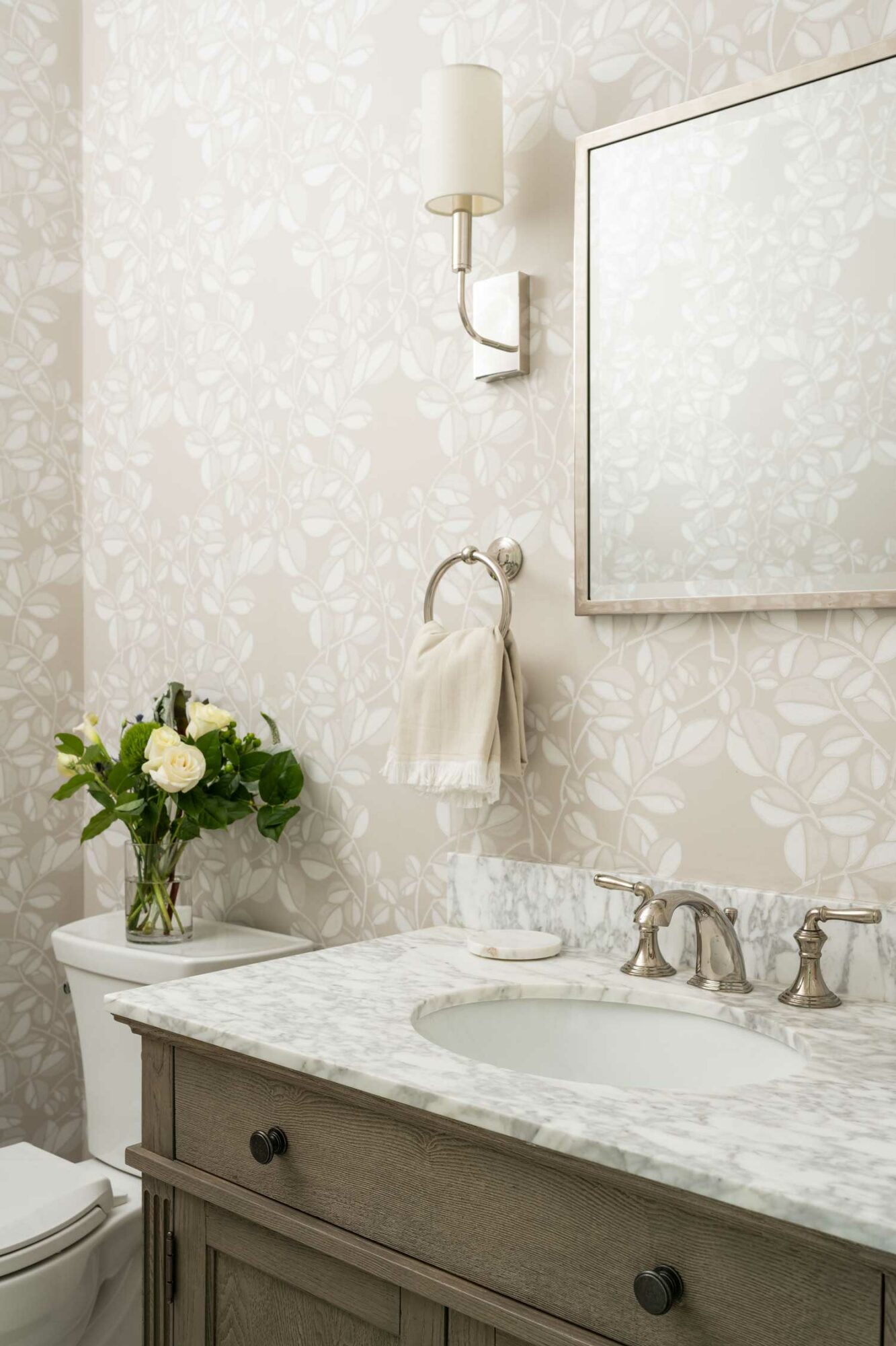 white bathroom with vanity and one of the 2023 wallpaper trends: textured wallpaper