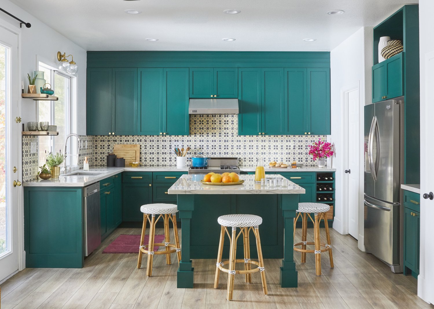 benjamin moore forest green is a beloved jewel tone paint color on the cabinets of this playful kitchen