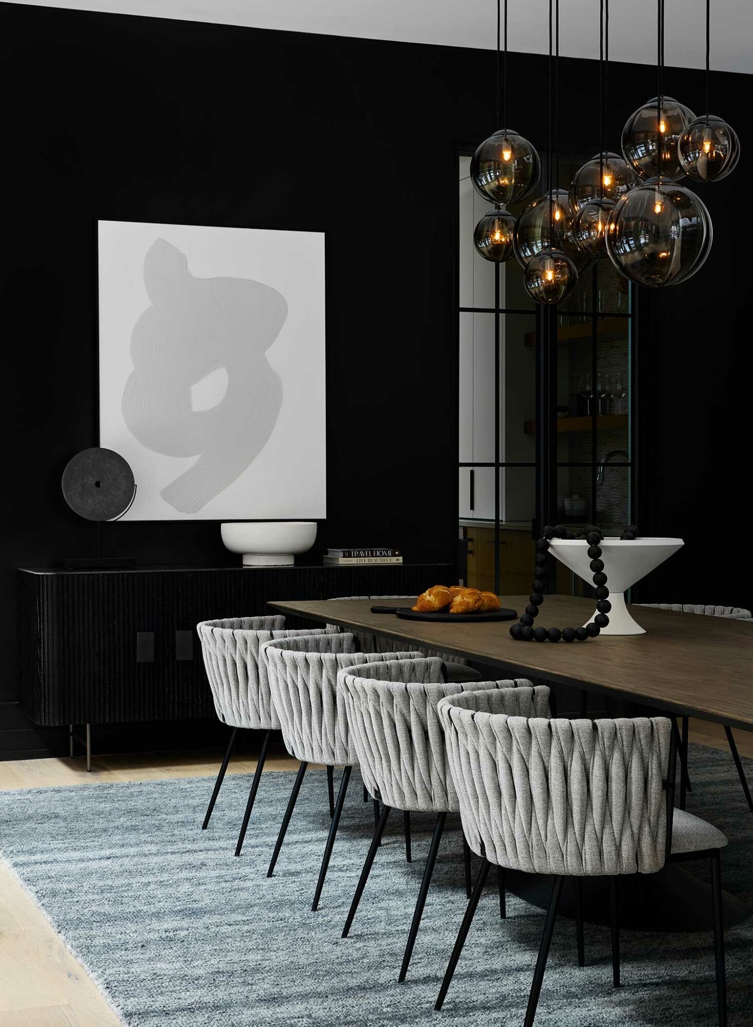 Black Beauty by Benjamin Moore on walls of dark dining room with a moody color vibe