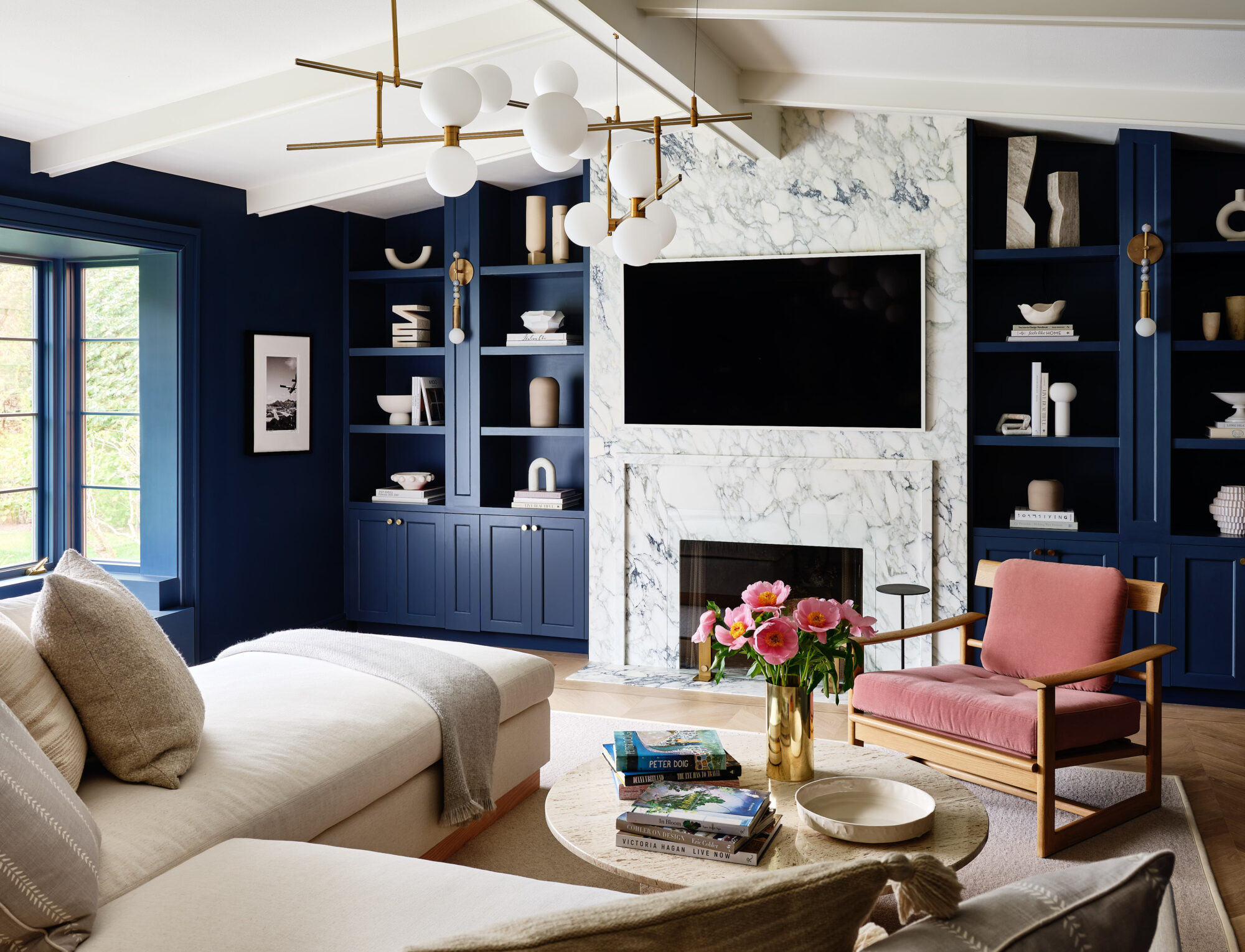 moody blue color in the navy by portola paints on the built-ins of a transitional living room 