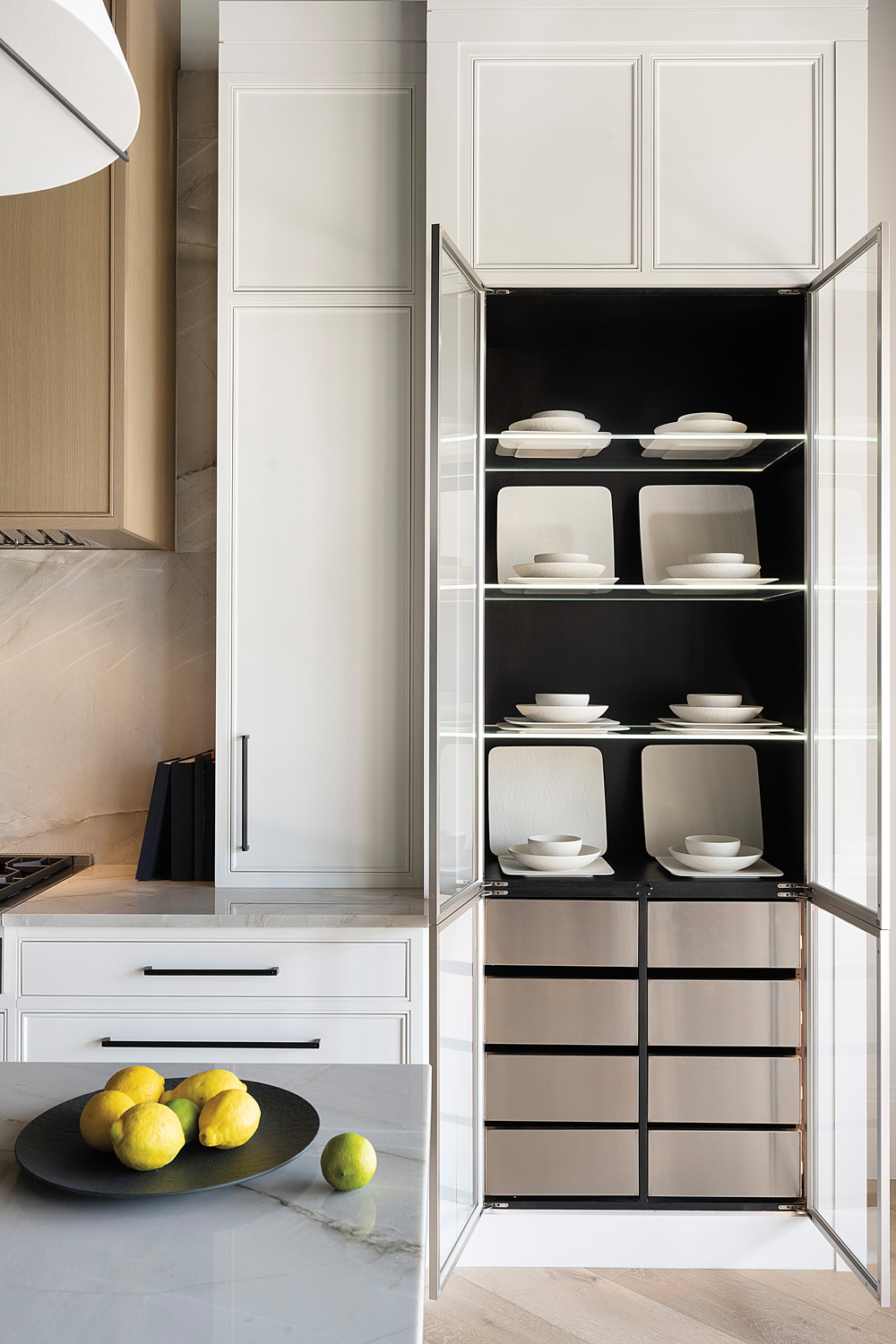 Kitchen vignette of white cabinetry and built-in shelving storage