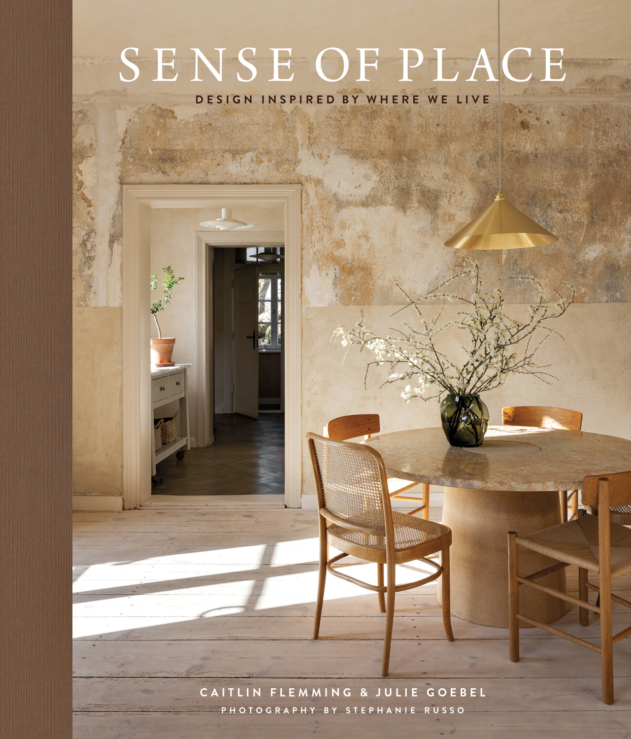 Cover of design book "Sense of Place," by Caitlin Flemming featuring a dining room in neutral tones