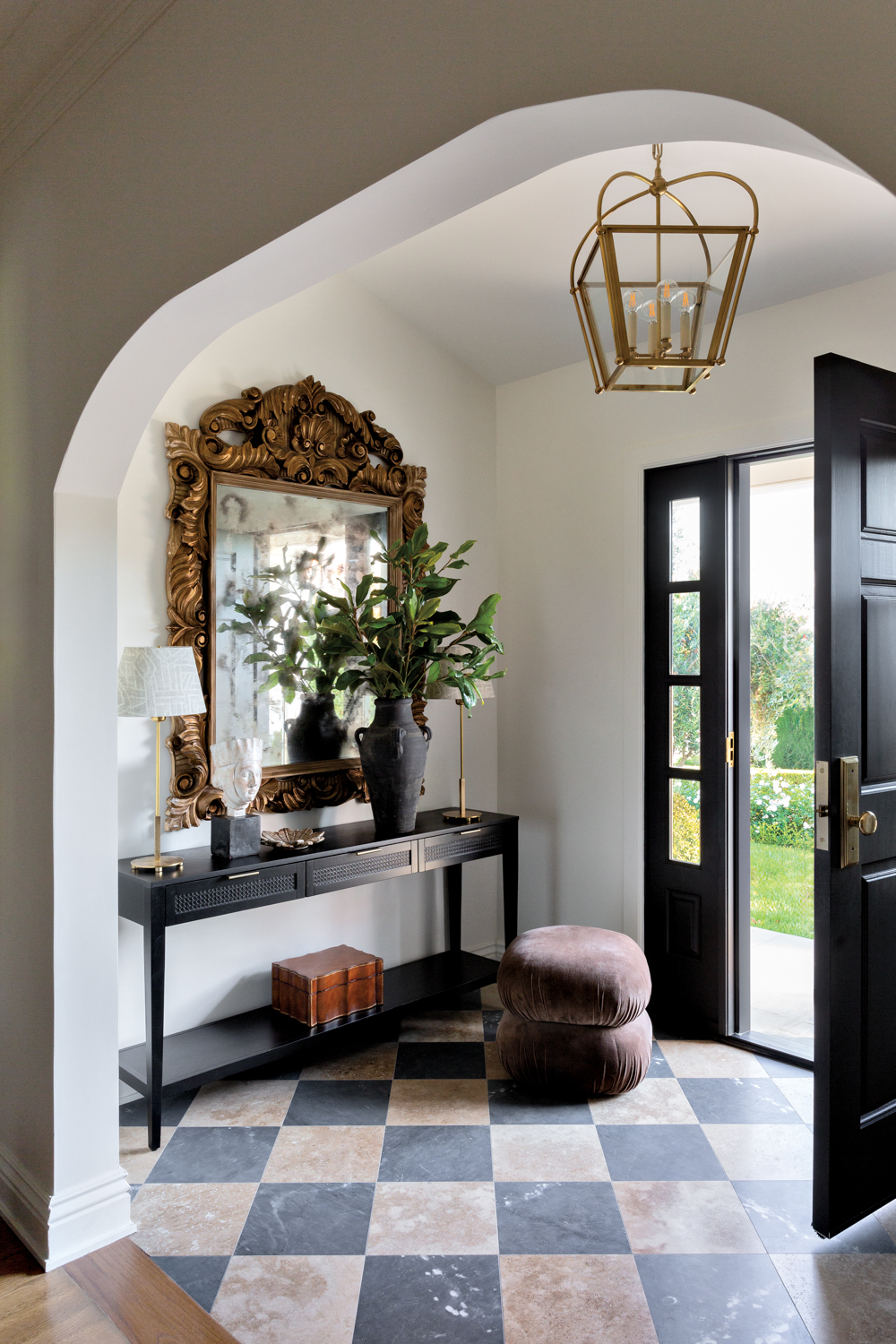 Foyer with black-and-white marble flooring,...