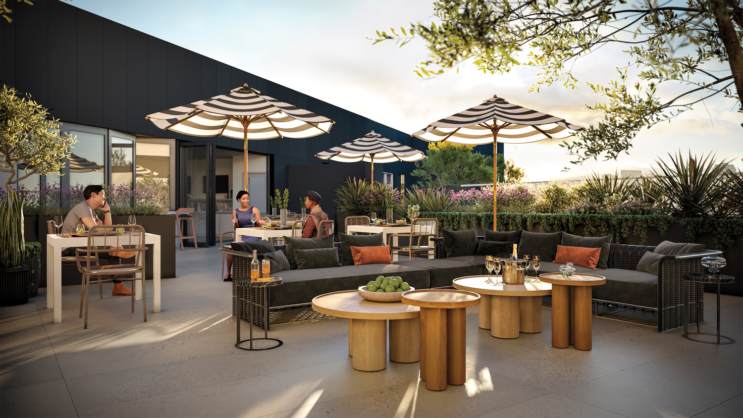 The outdoor terrace at West Edge, with striped umbrellas, black sofas and natural-wood nesting coffee tables