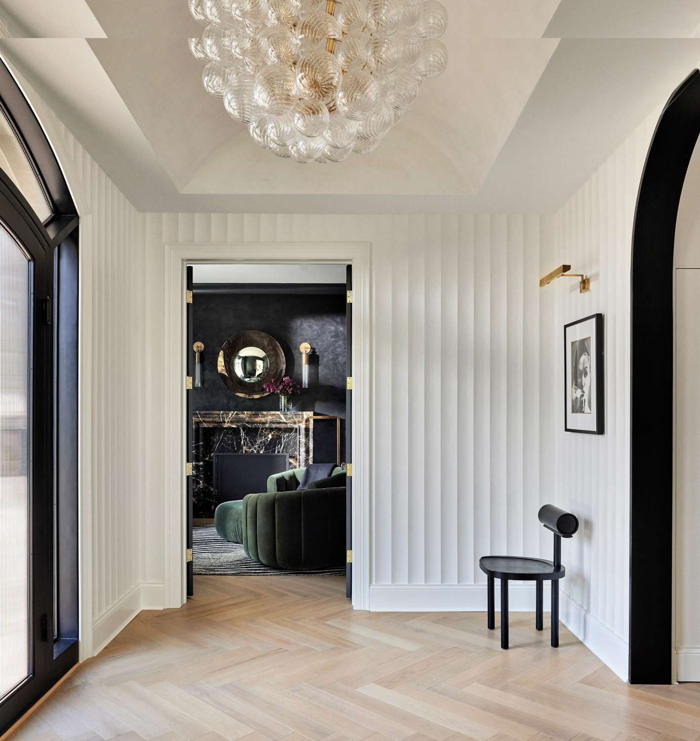a foyer with white fluted-wood...