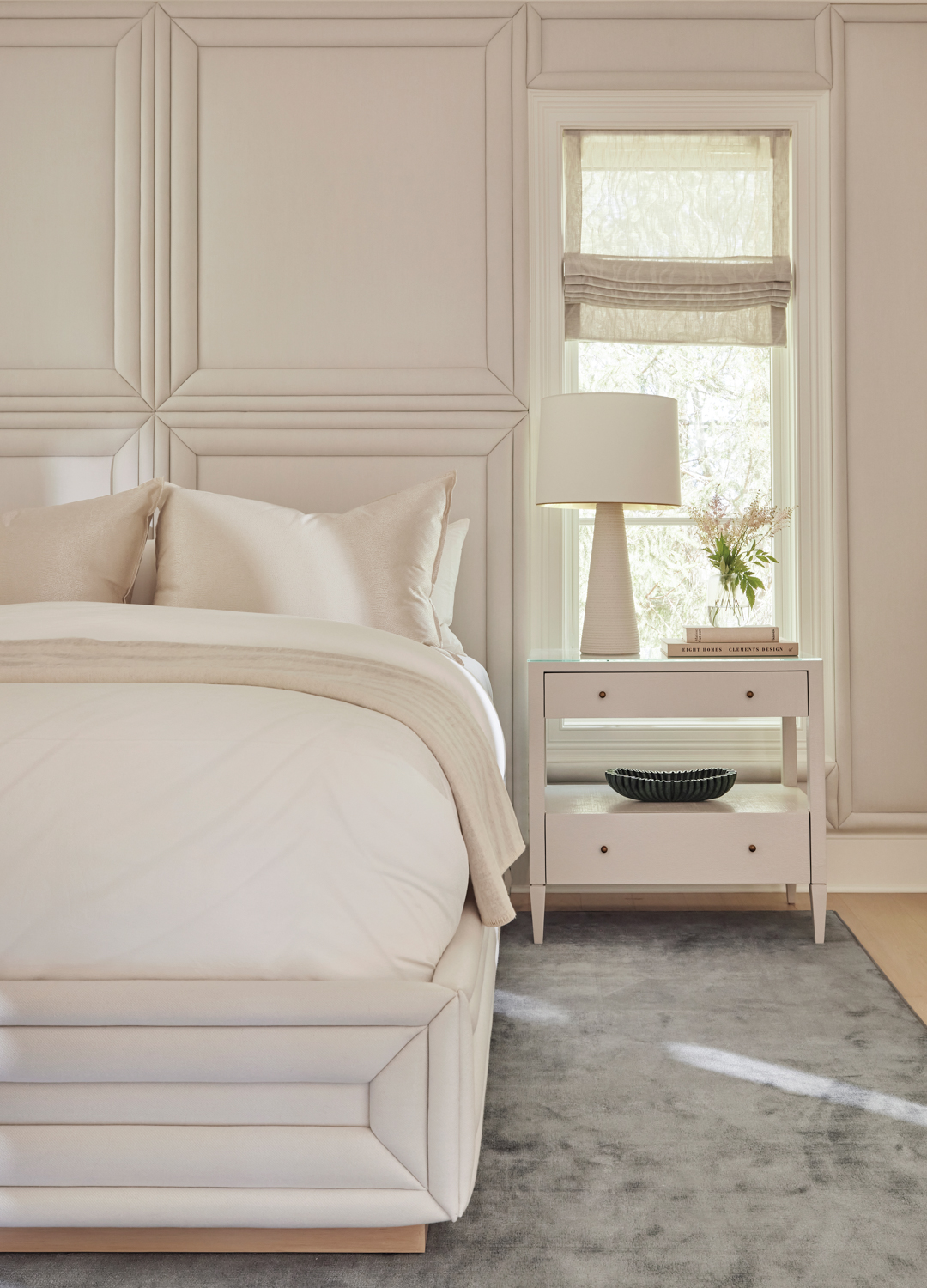 an all-white bedroom with an...