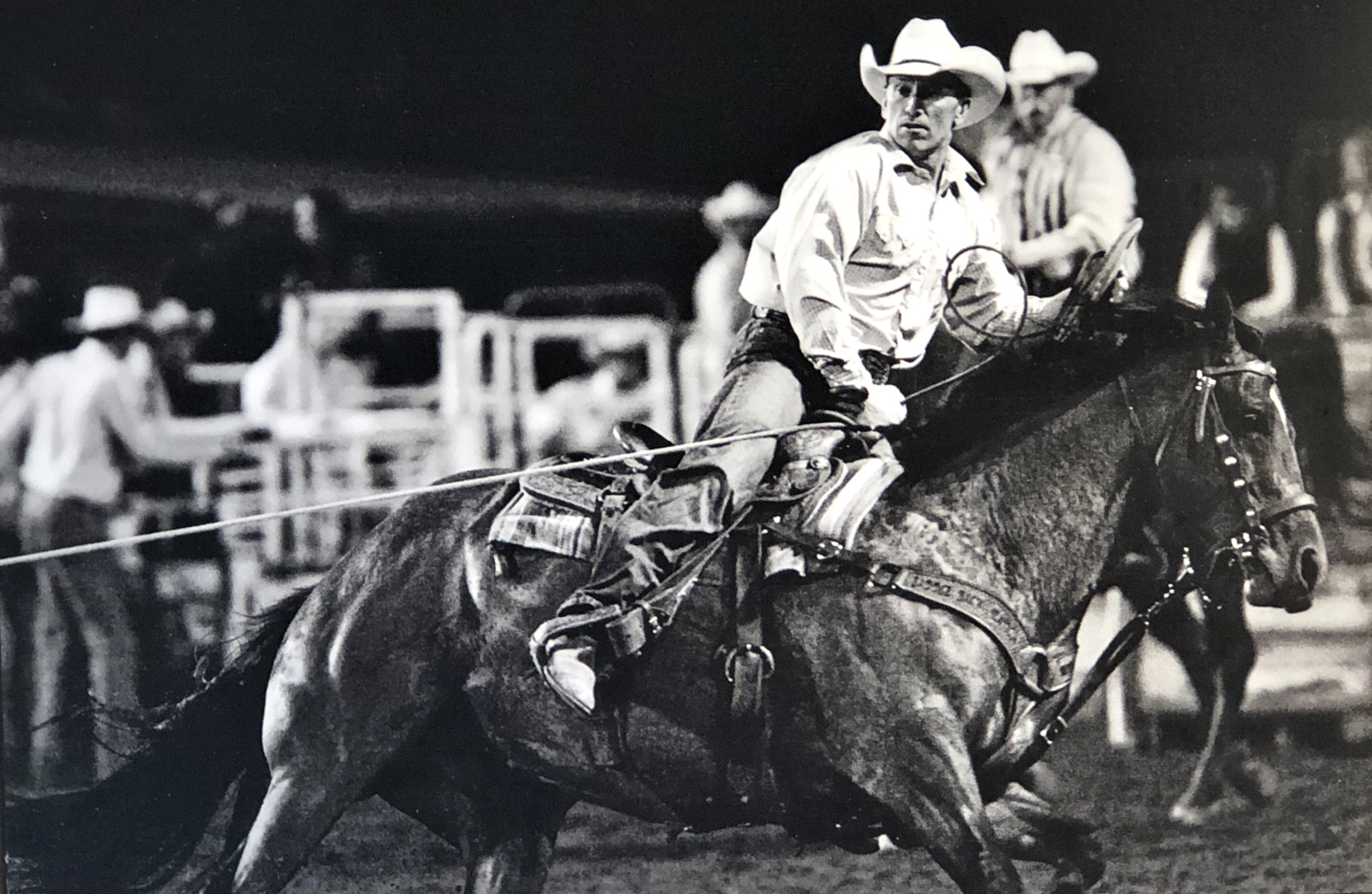 Black-and-white photo of Jace Romick performing rodeo on a horse