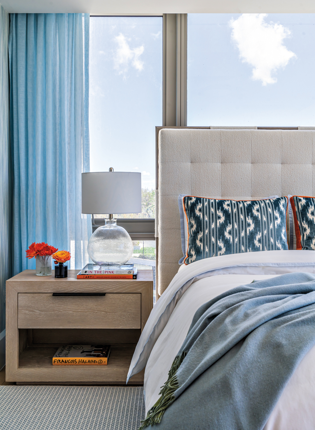 guest bedroom with blue draperies,...