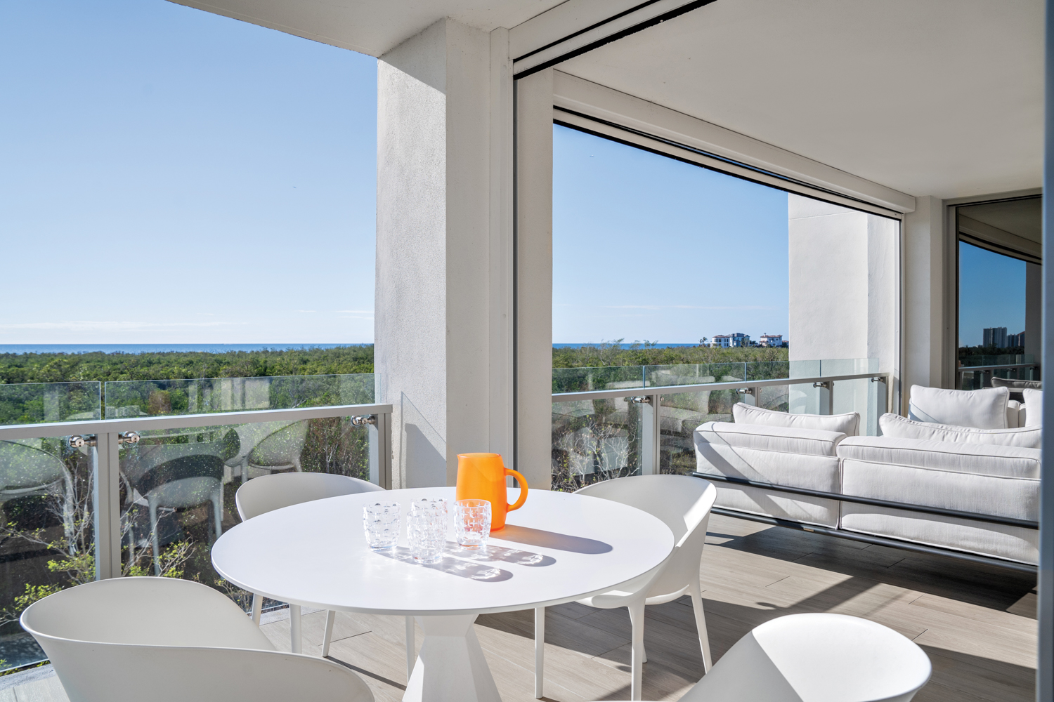 balcony with white outdoor table,...