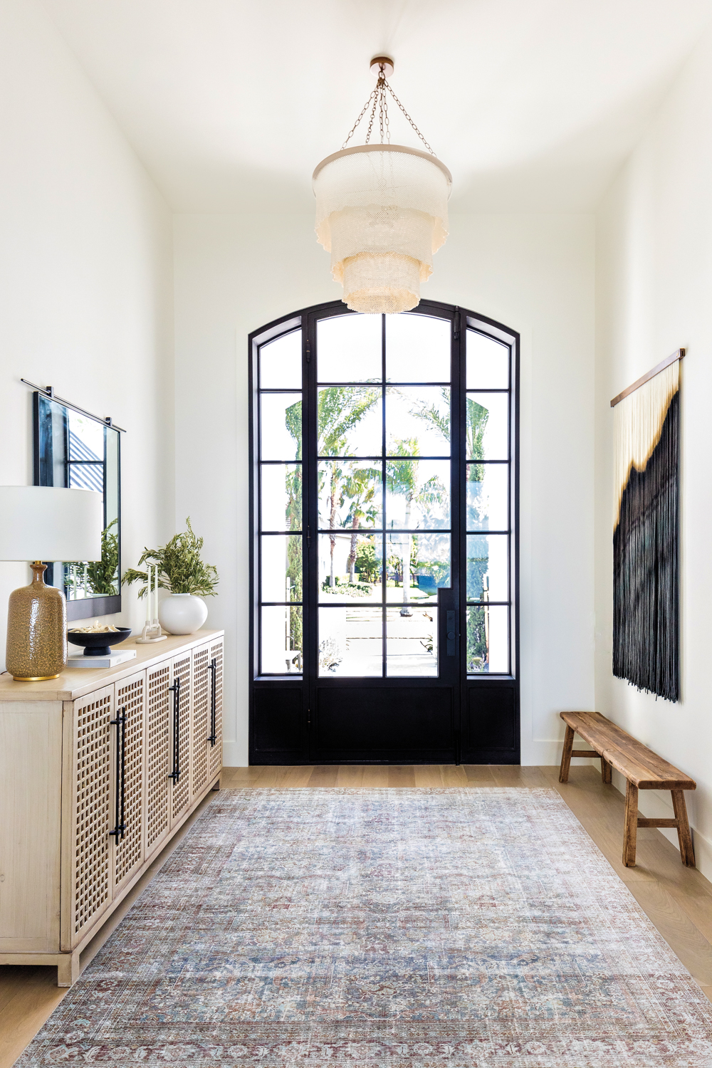 foyer with cream-colored walls, black...