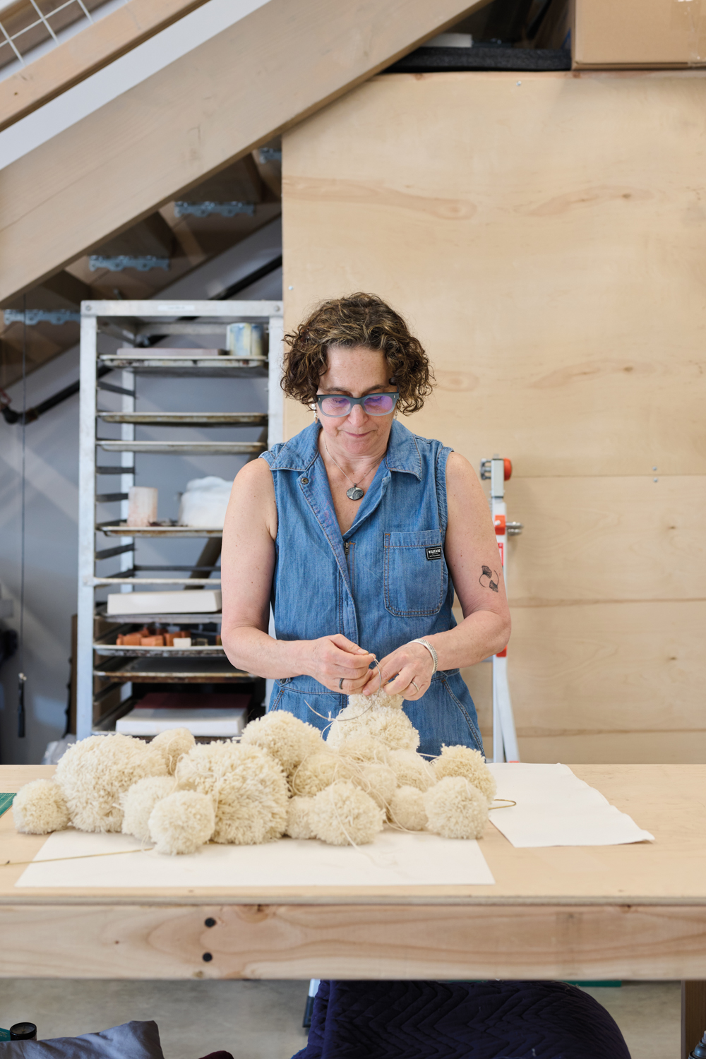 Artist Nancy Mintz works with wool pompoms