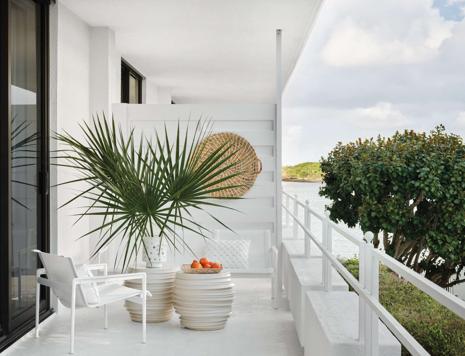 white balcony with loveseat, armchair,...
