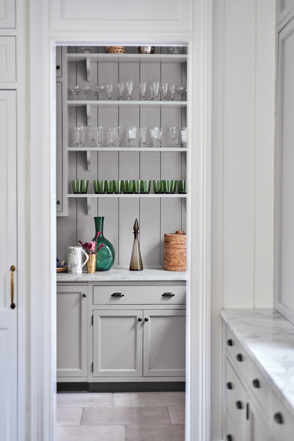 Gray pantry featuring expert millwork...