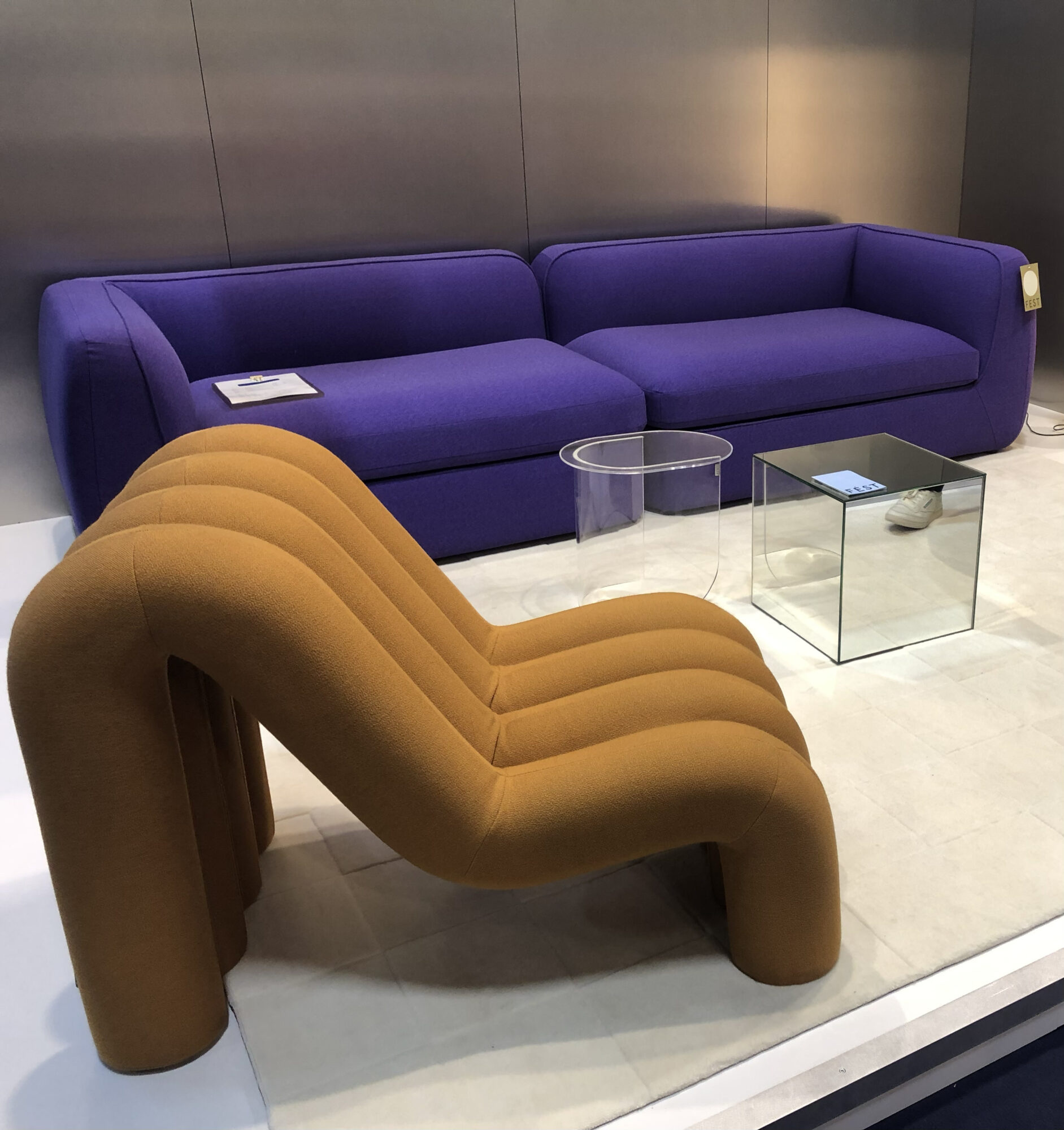 dark purple couch and curved orange chair