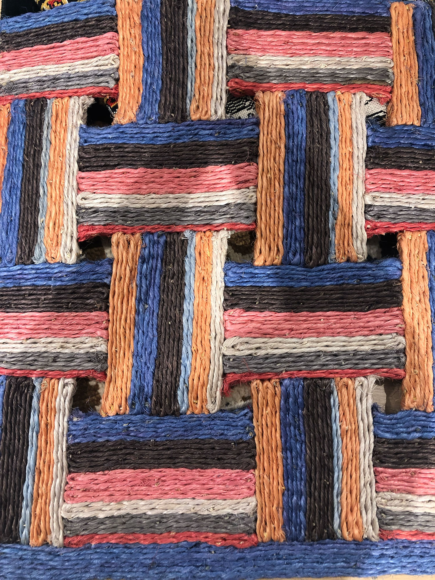 orange, blue, brown and white striped rug