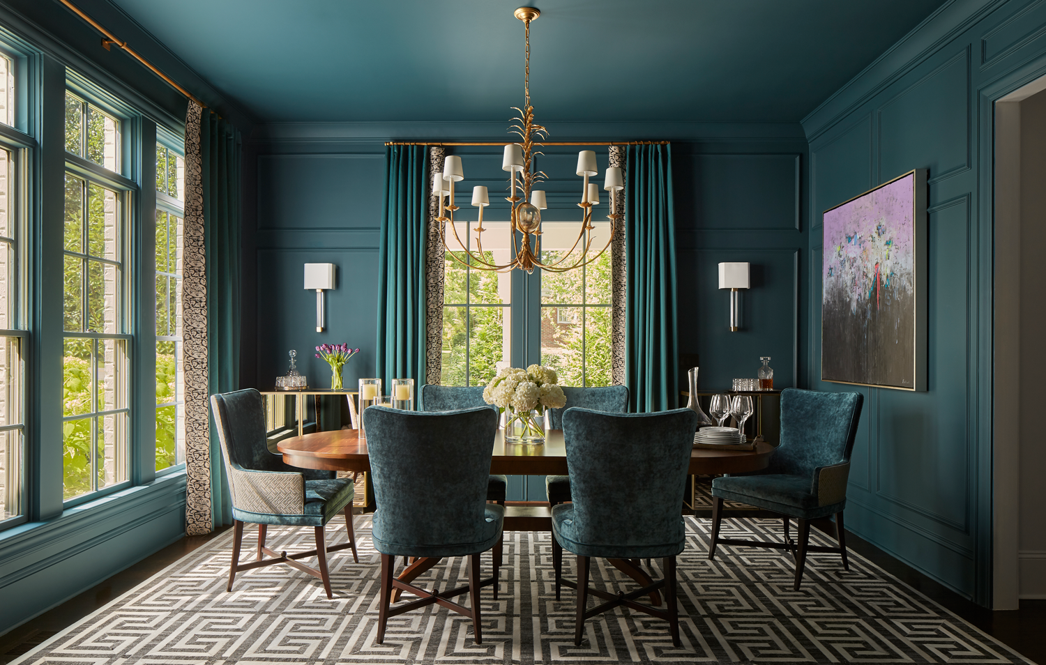 dark green dining room with matching velvet chairs and drapes