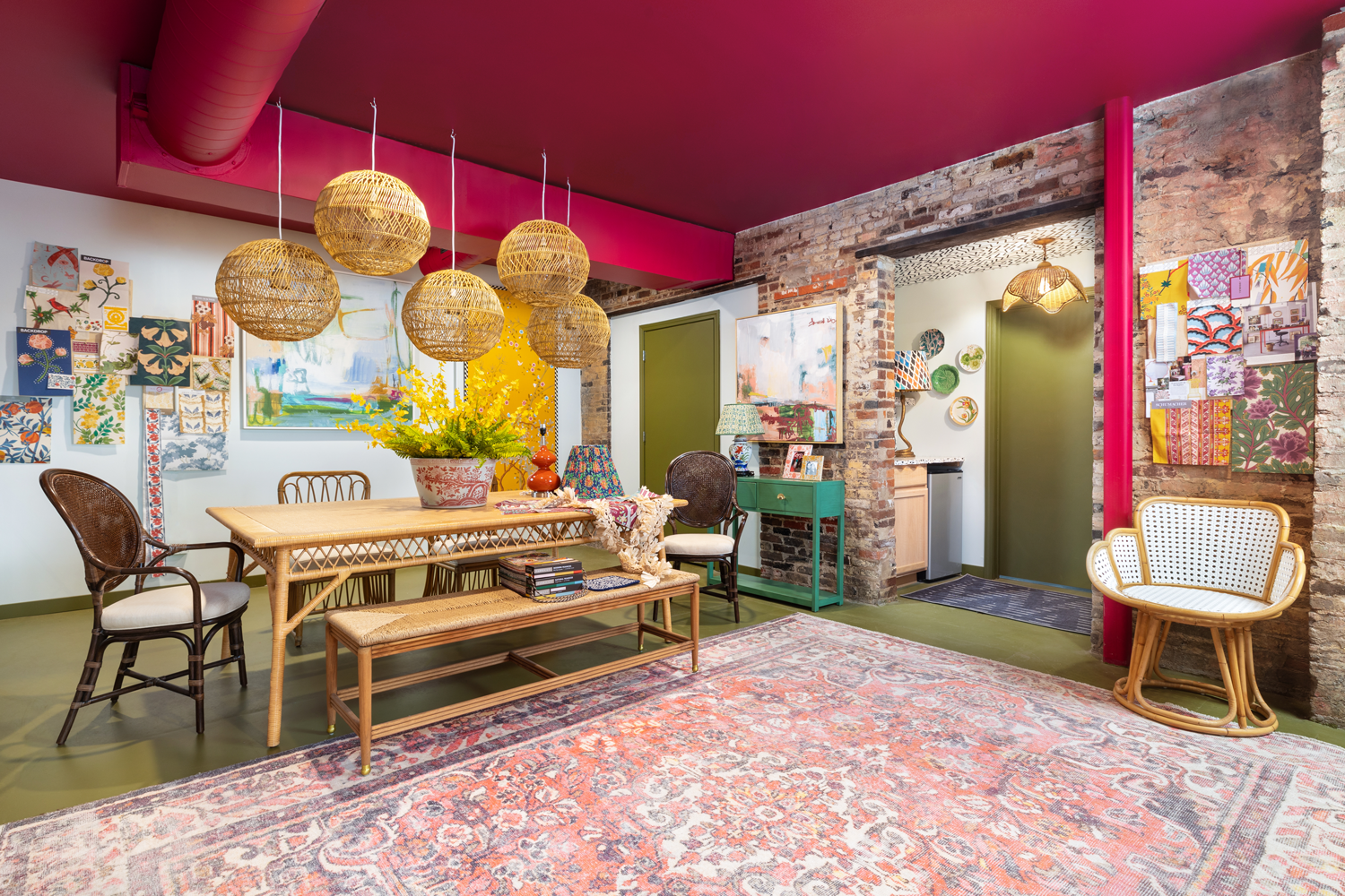 office space with bright pink ceiling, globe lamps and long table