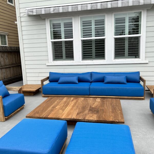 Teak outdoor deep seating sofa and table with teal cushions on outdoor patio by Willow Creek Designs in Los Angeles, California