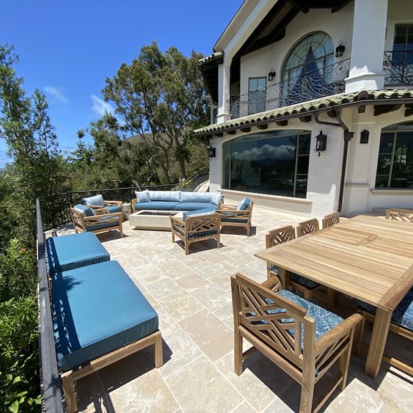 Teak outdoor sofa and table with teal cushions next to pool by Willow Creek Designs in Los Angeles, California