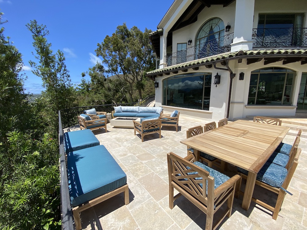 Teak outdoor sofa and table with teal cushions next to pool by Willow Creek Designs in Los Angeles, California