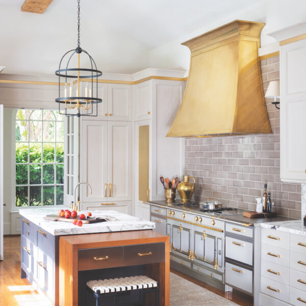 The Arcadia Hood by Francois & Co in kitchen with white cabinets and gold accents