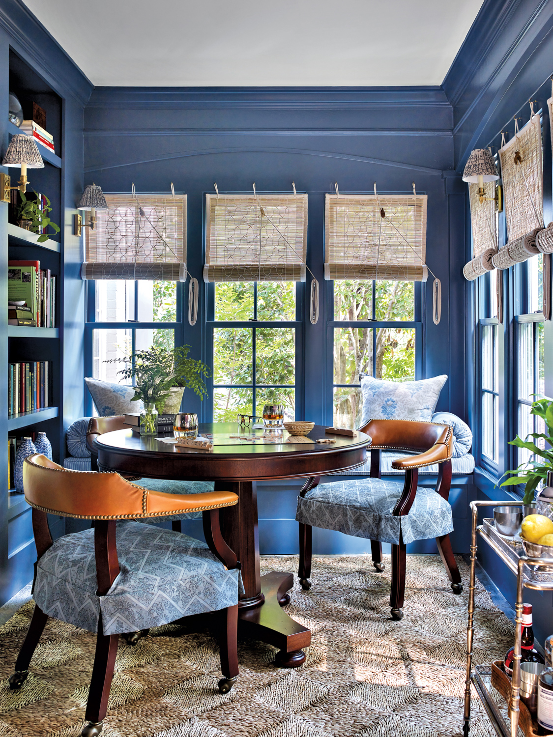 Lauren E. Lowe office nook with dark wood table and chairs upholstered in a blue fabric and painted blue