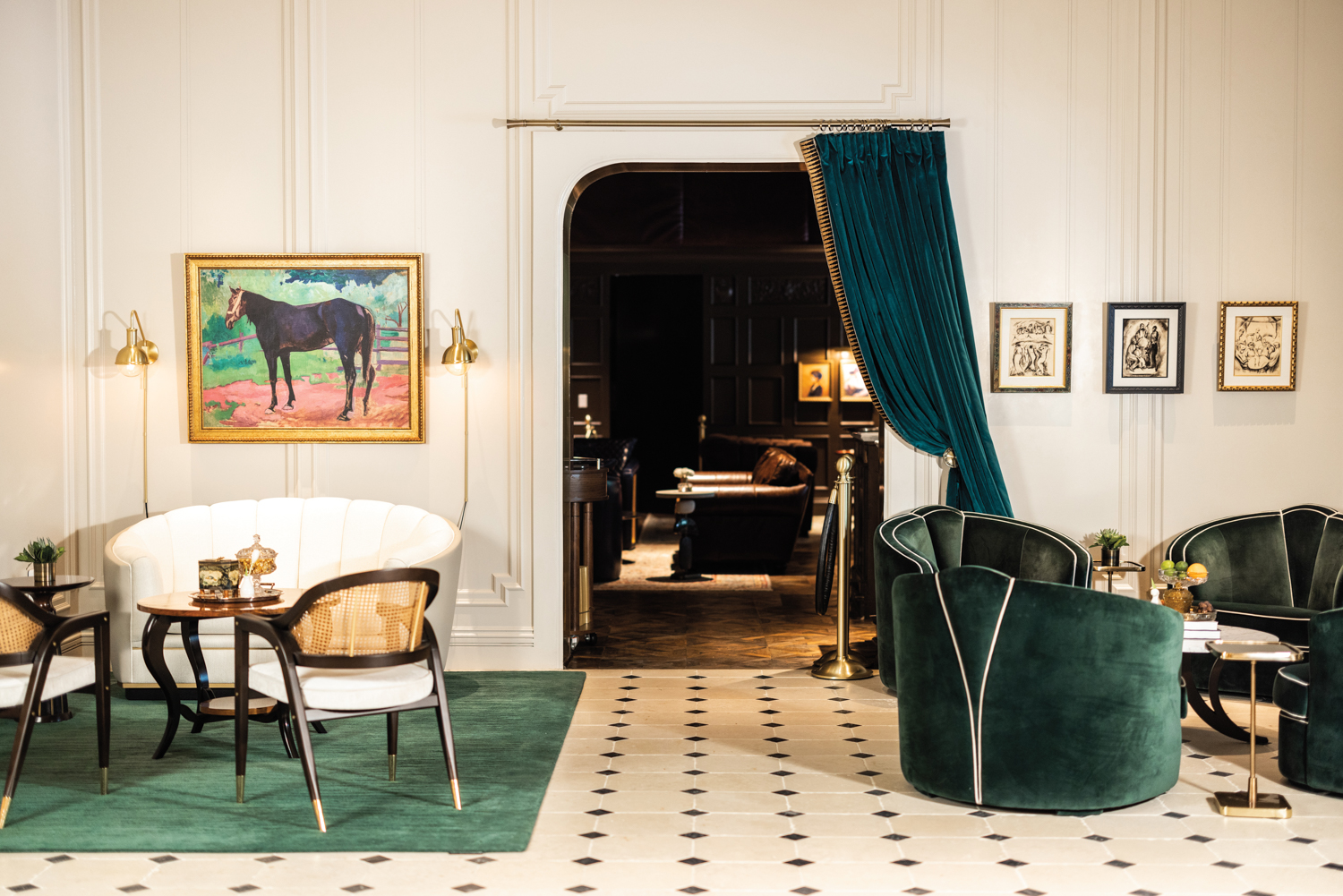 Hôtel Swexan room with plush green armchairs, small side tables and horse portrait