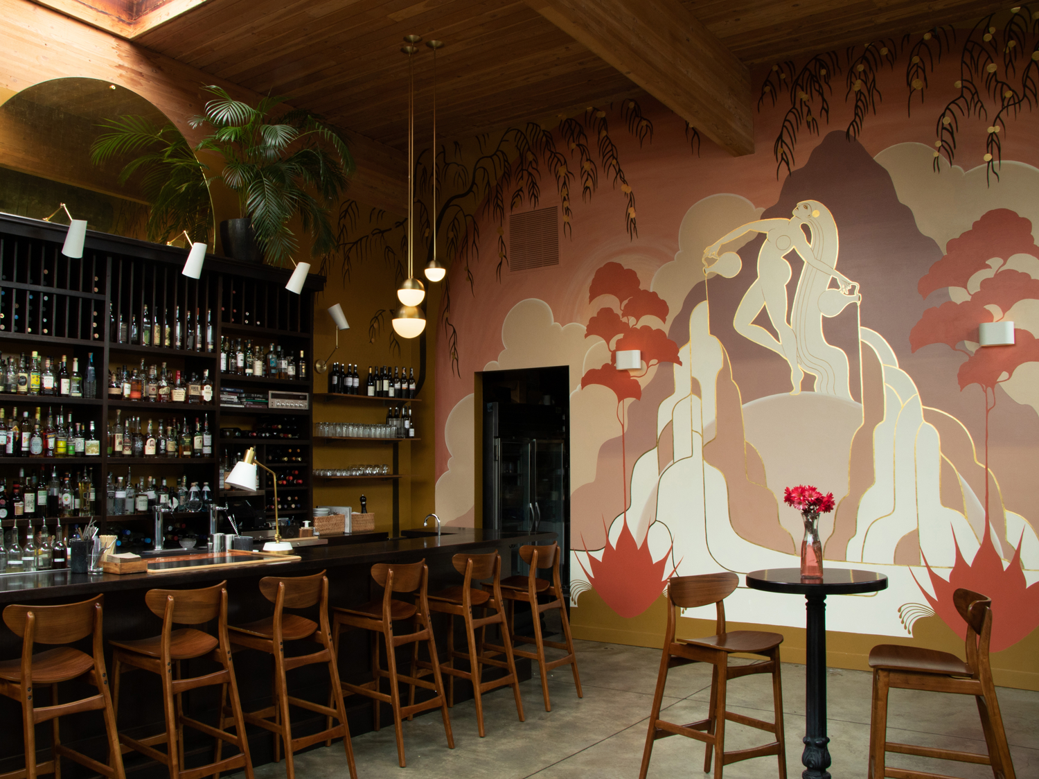 bar with patterned wallpaper and bar stools