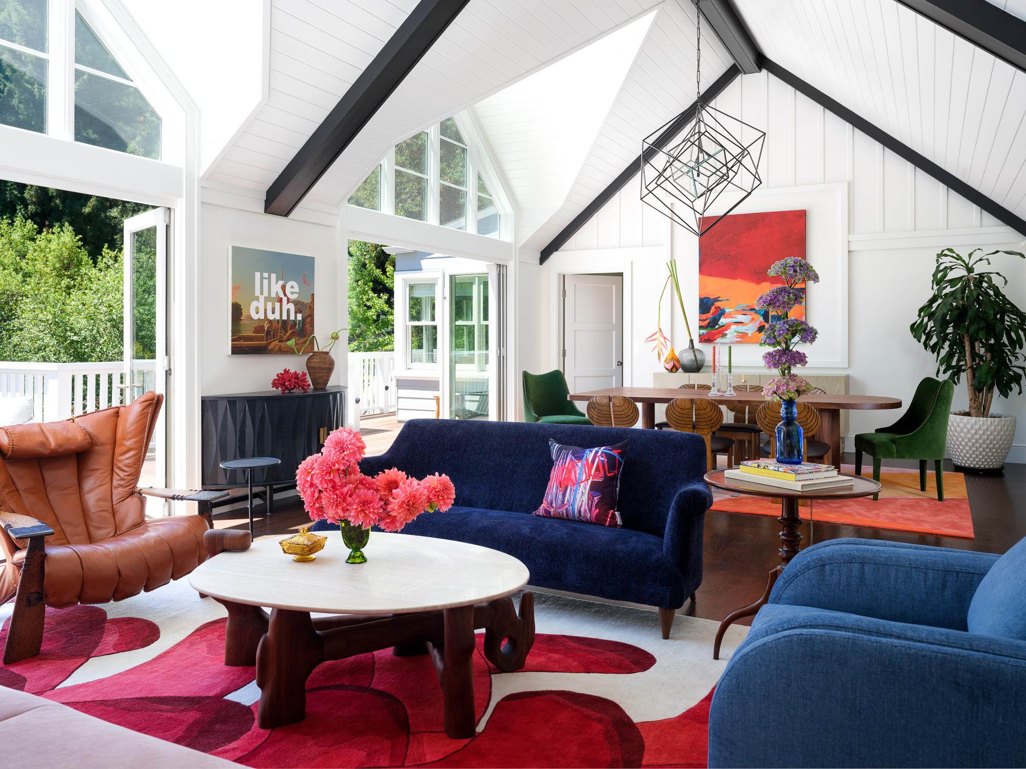 living room with bright red flooring and blue couches, part of 2024 paint color trends