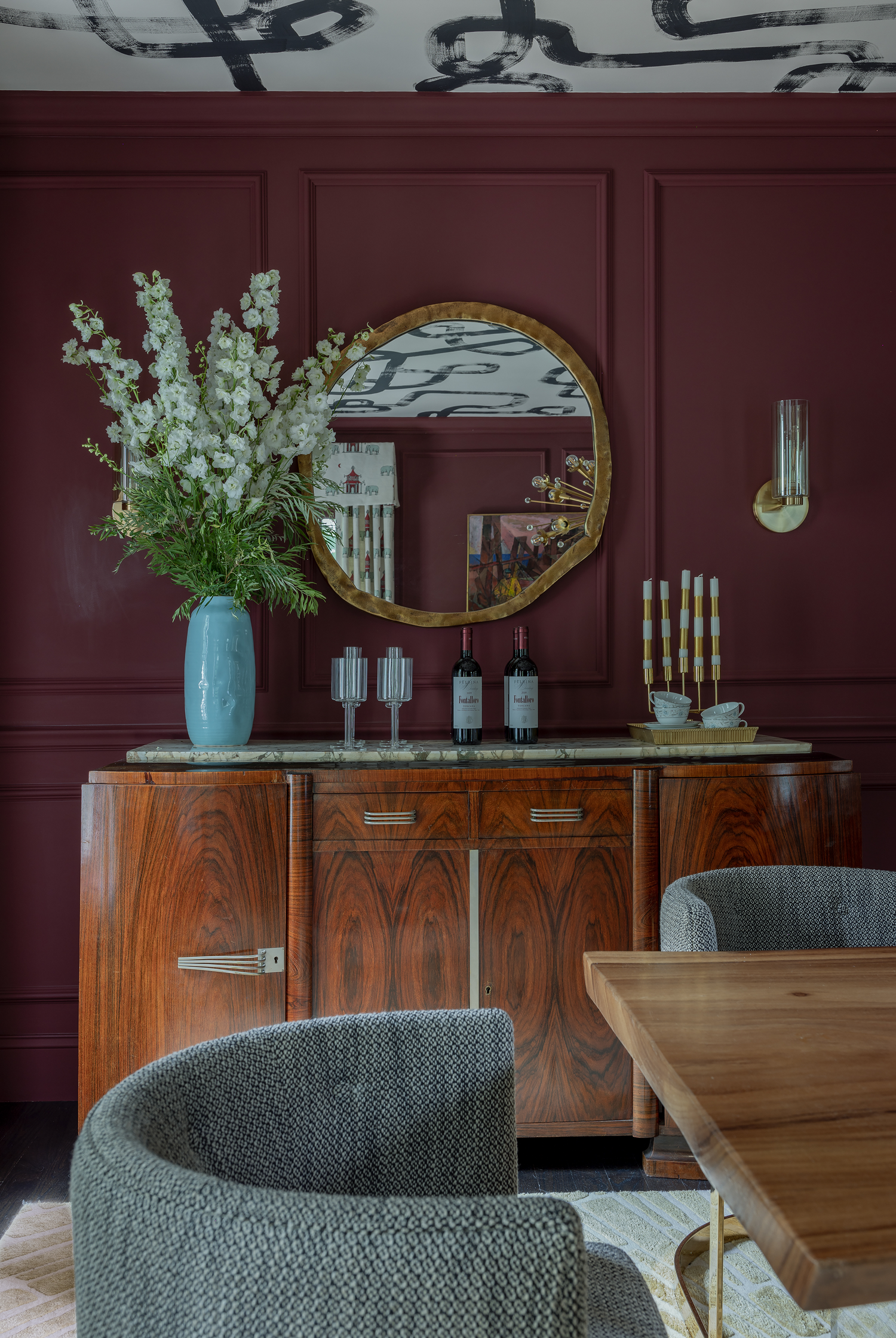 dining room painted with dark plum red, one of the 2024 paint color trends