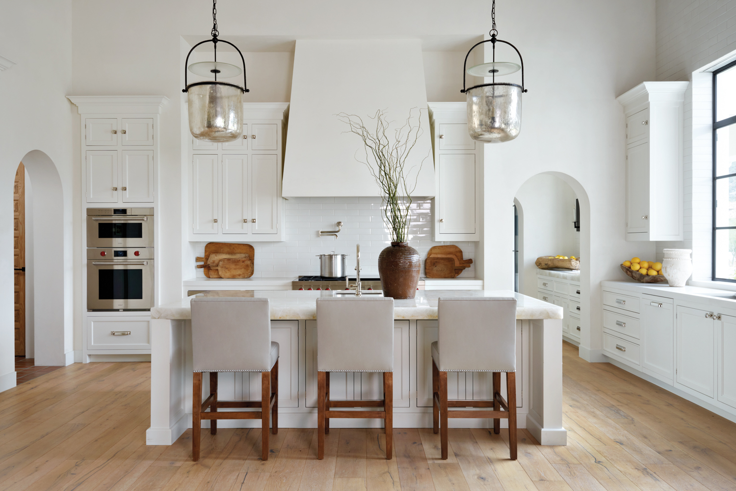 white kitchen with gray stools...