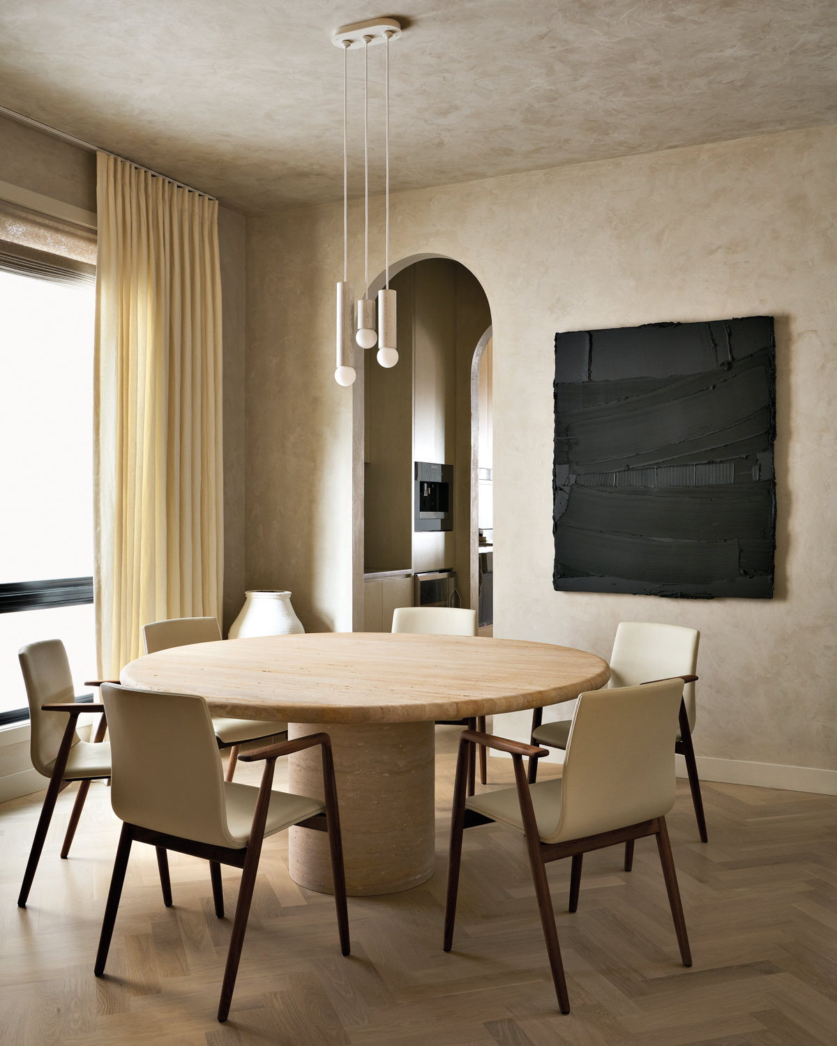 Travertine dining table is surrounded...