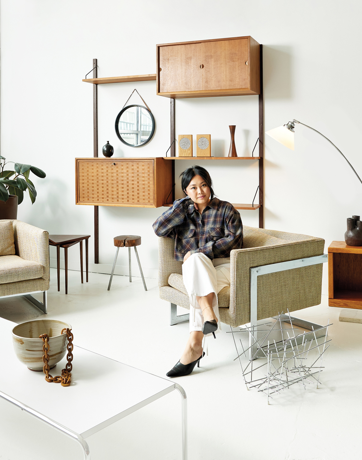 Alana Tang sitting in chair in her Seattle shop