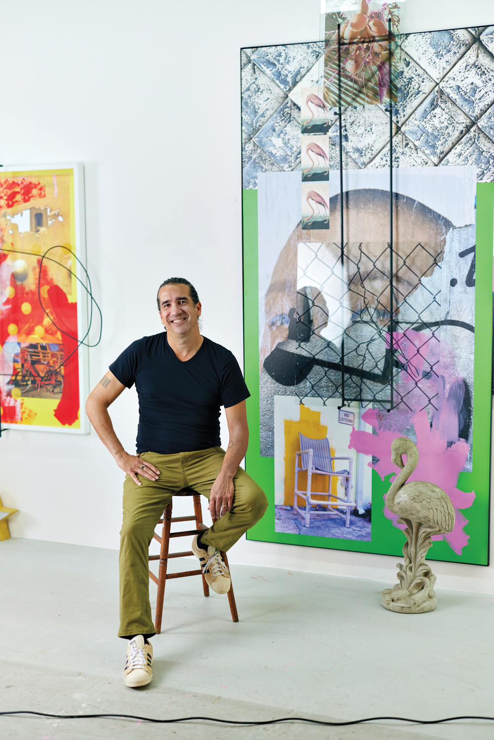 michael loveland sitting on a stool in his studio