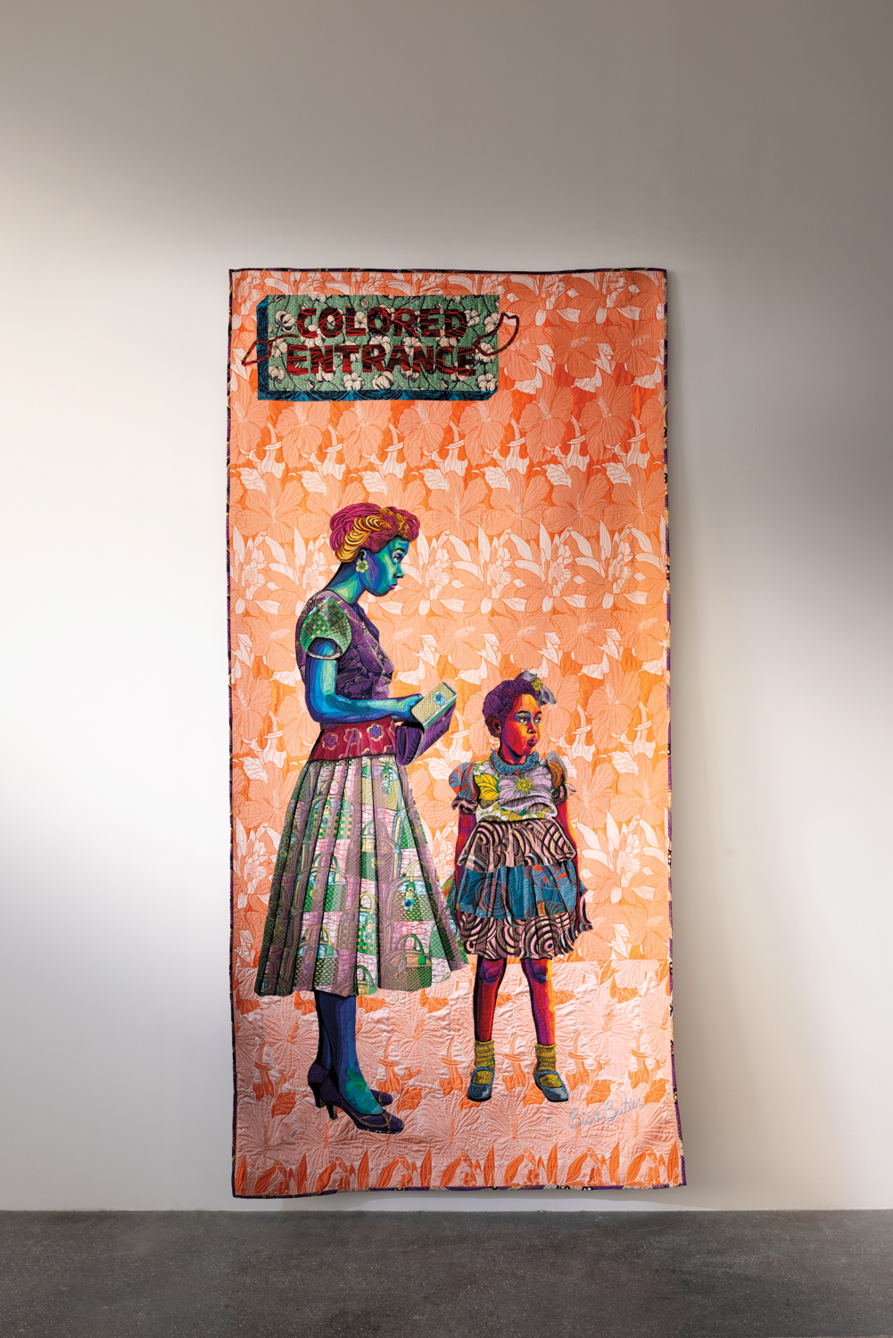textile portrait of two Black women at entrance