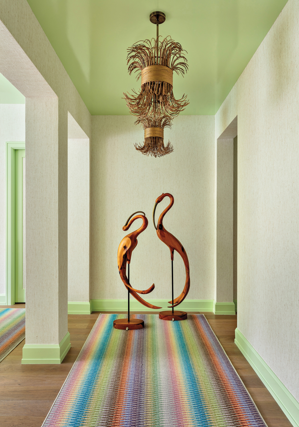 hallway with light green wallcovering...
