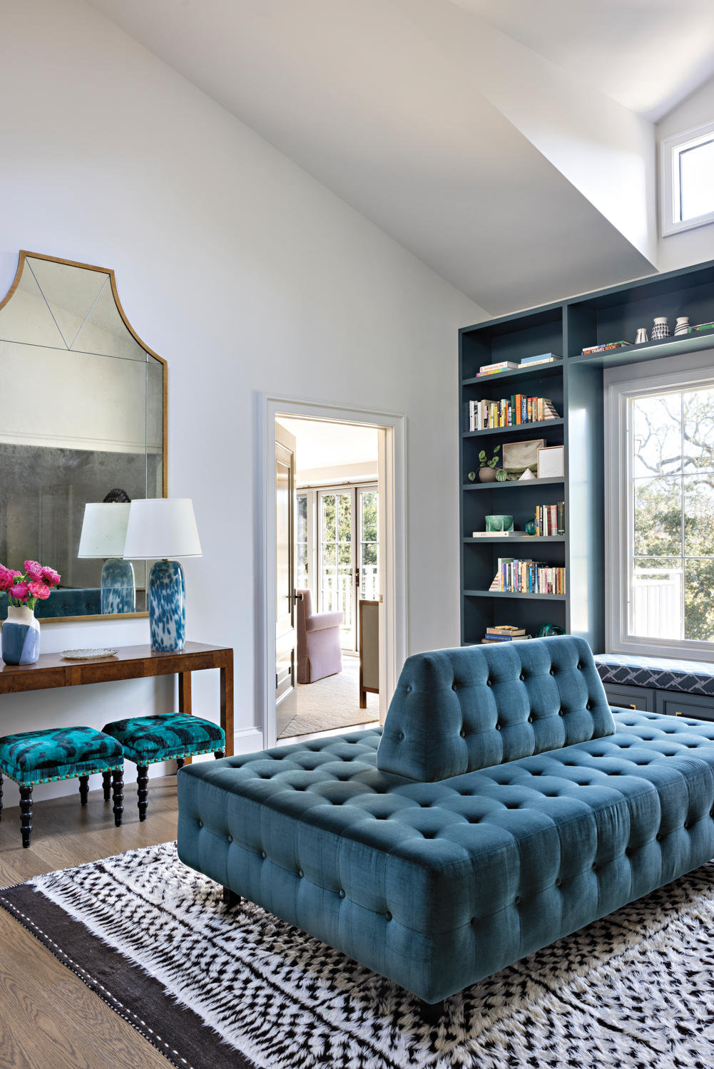A blue tufted settee allows...
