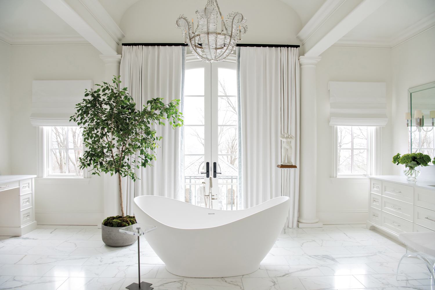 Sunlit bathroom with white finishes,...