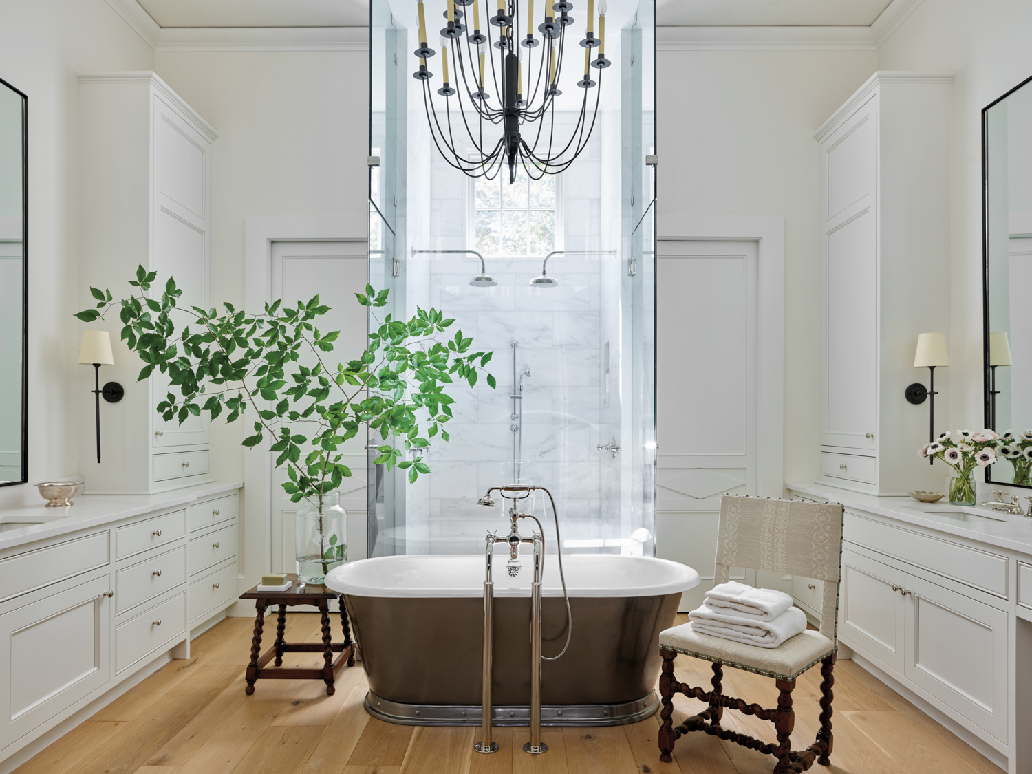 Primary bathroom with show-stopping chandelier,...