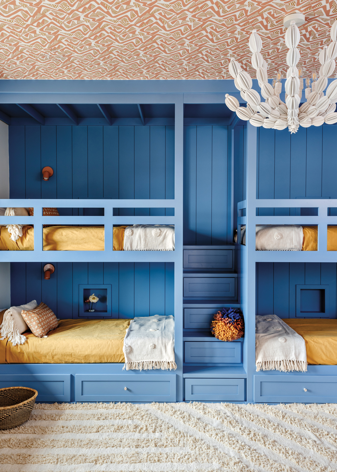 Four-bed bunk room with blue-painted...
