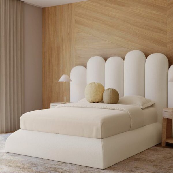 primary bedroom with white bedding and white headboard and circle pillows