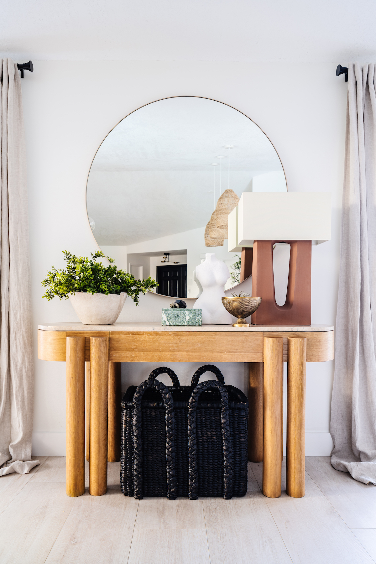 Entry table, black stools, large mirror, grey drapes