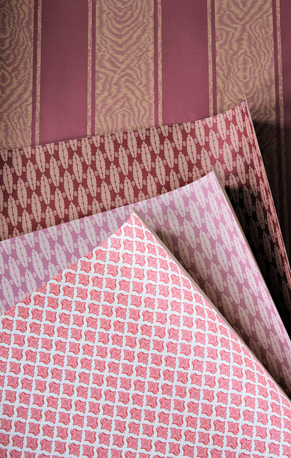 Four different pink patterned wallpaper samples