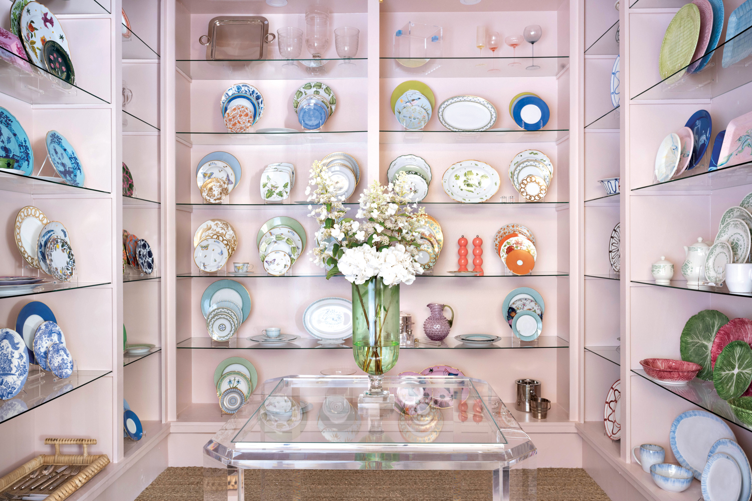 Three-walled alcove with glass shelving displaying assorted china and glassware at Blue Print