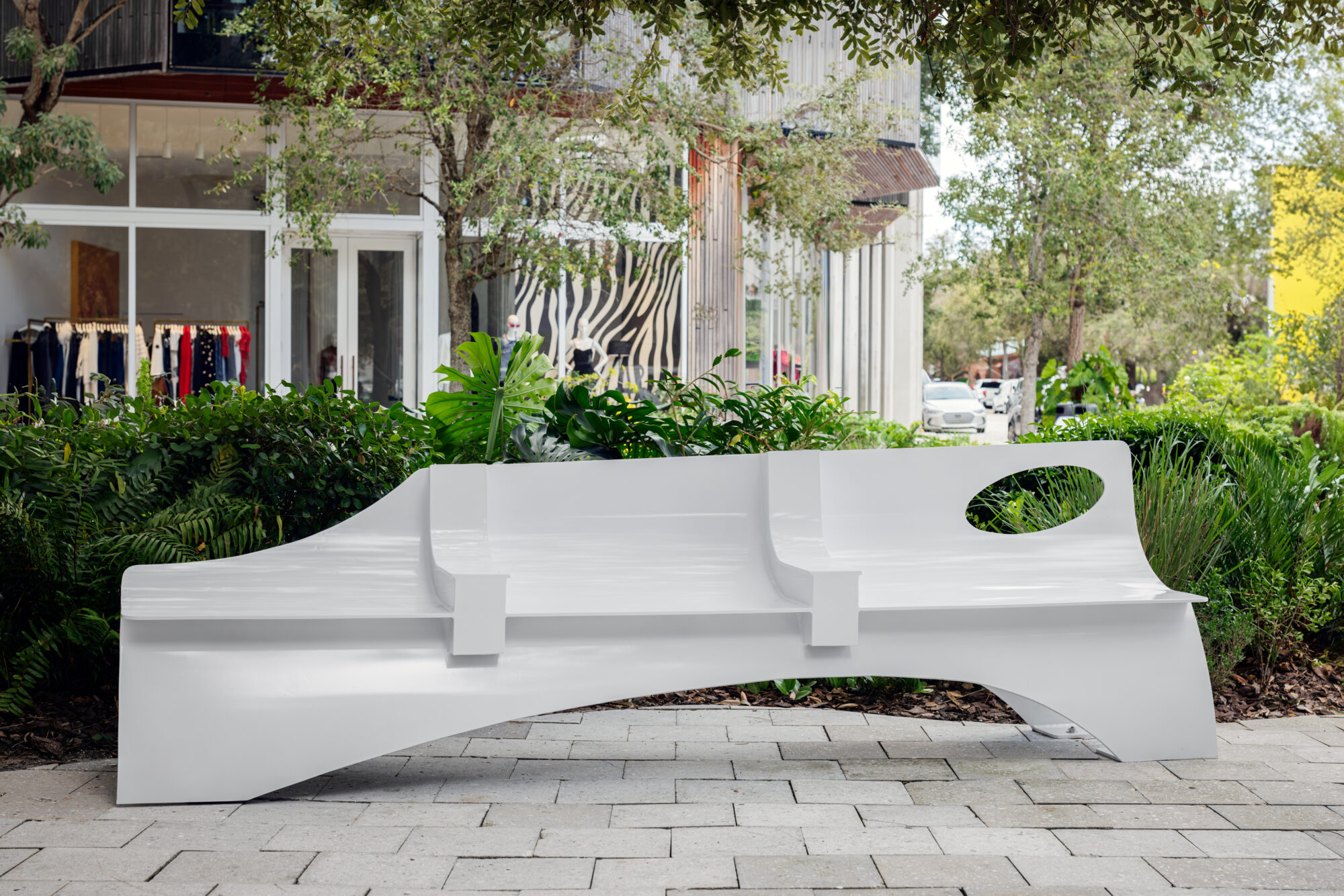 white bench outside in courtyard facing building