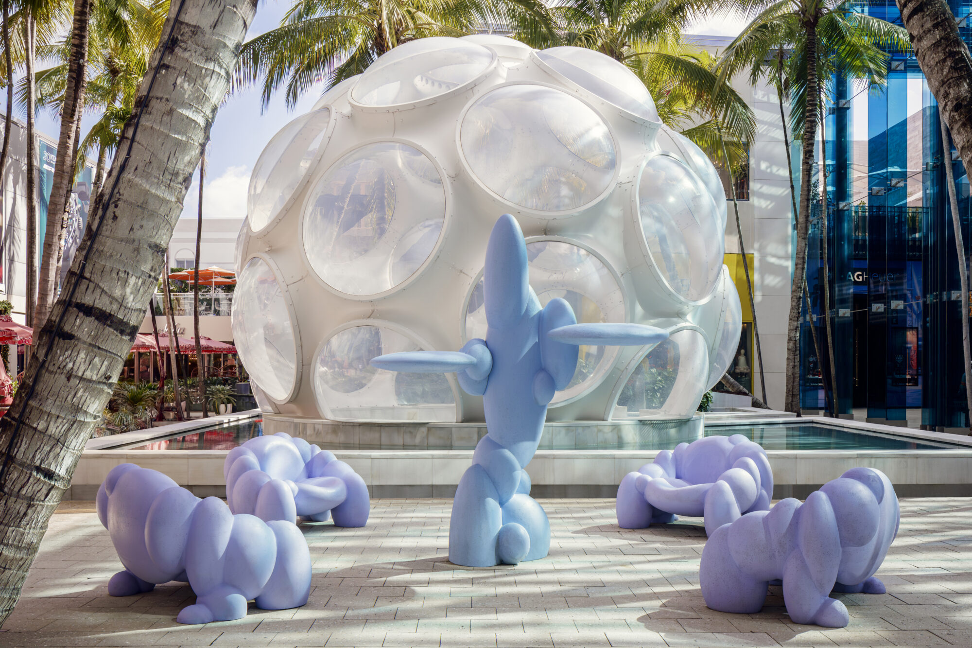 bubble structure behind varying amorphous blob seating and sculptures