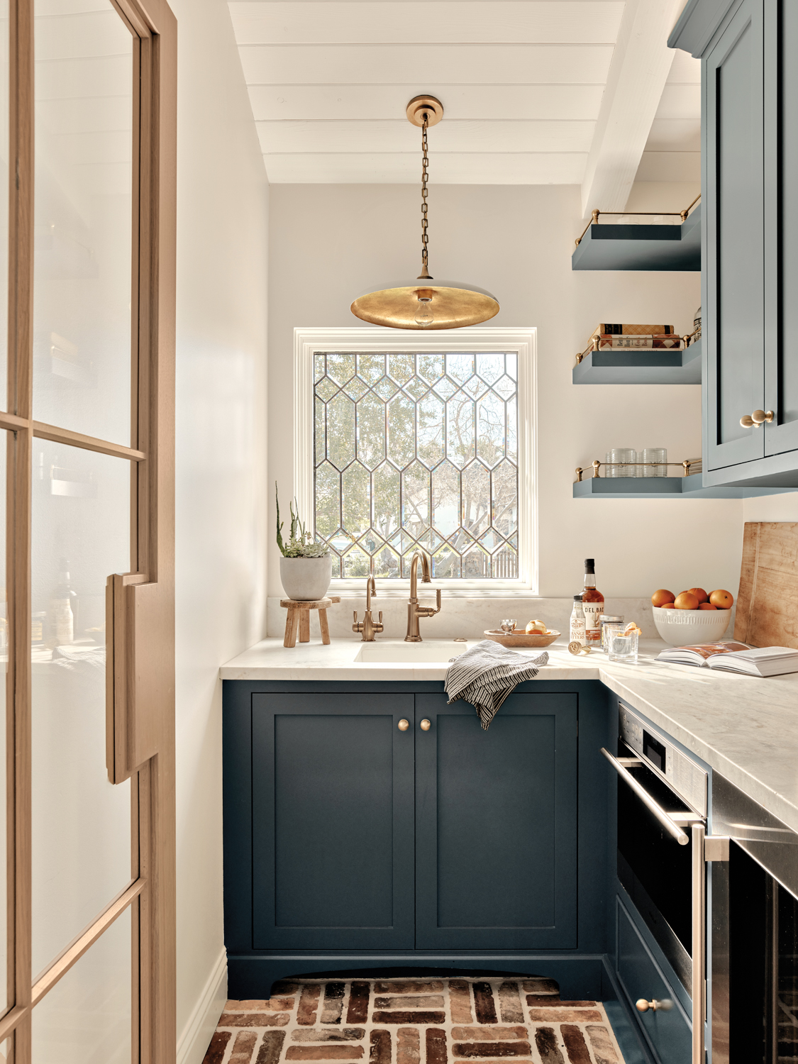 Pantry with dark blue cabinetry,...