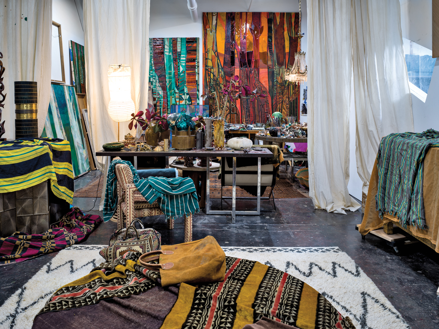 Artist Leslie Nix's studio filled with paints and vibrant fabrics